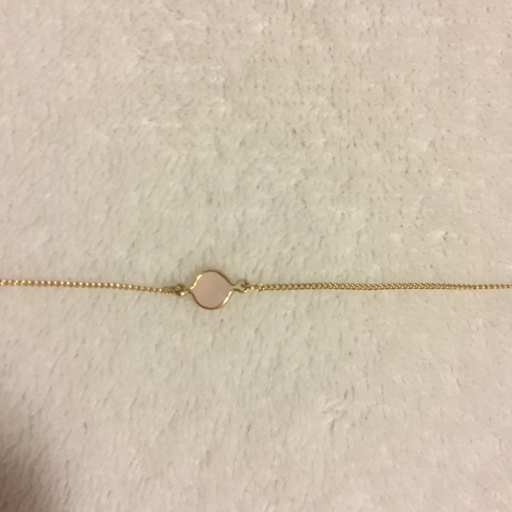 Gold choker necklace w/ blush stone at the center